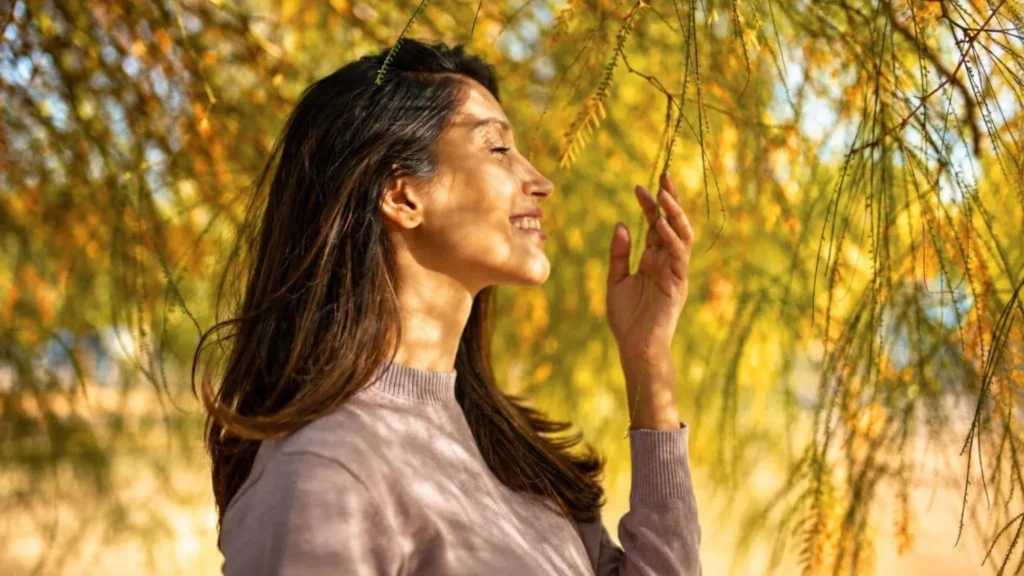 Woman enjoying sunshine outdoors in fall