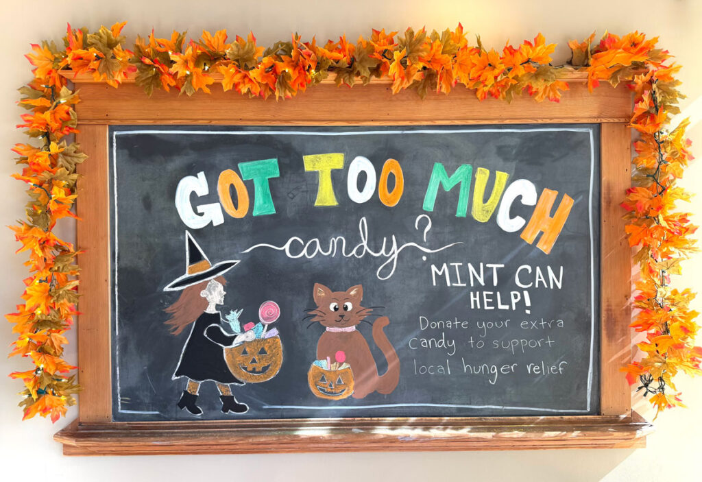 Hand-drawn Halloween chalkboard at Mint Dental Works in SE Portland asking families to donate extra candy